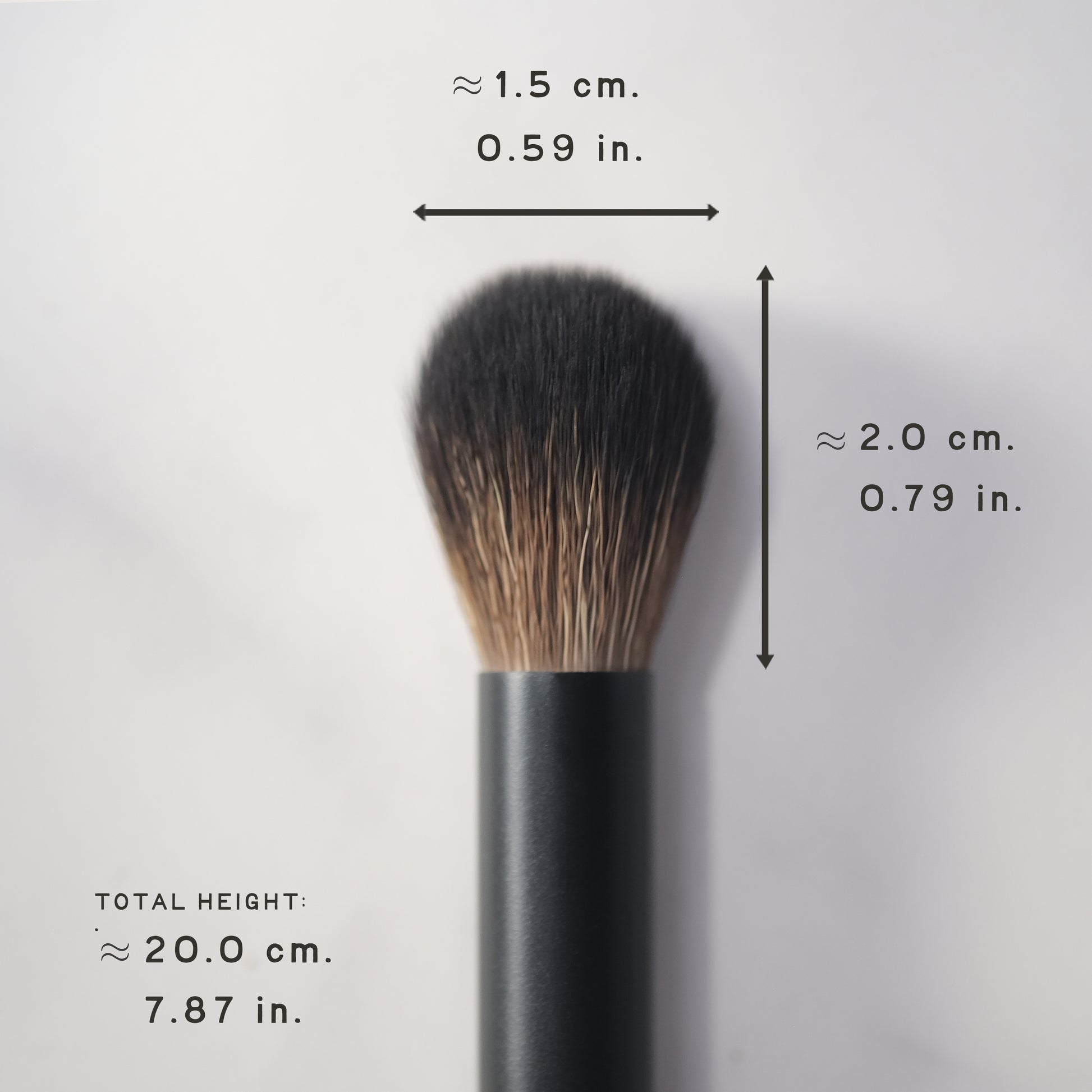 Makeup brush with measurements on a light gray background