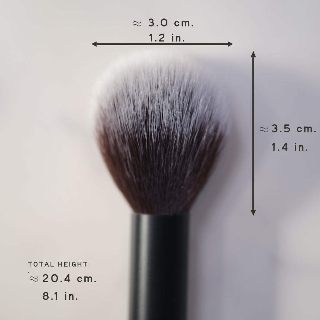 Makeup brush with measurements on a light gray background