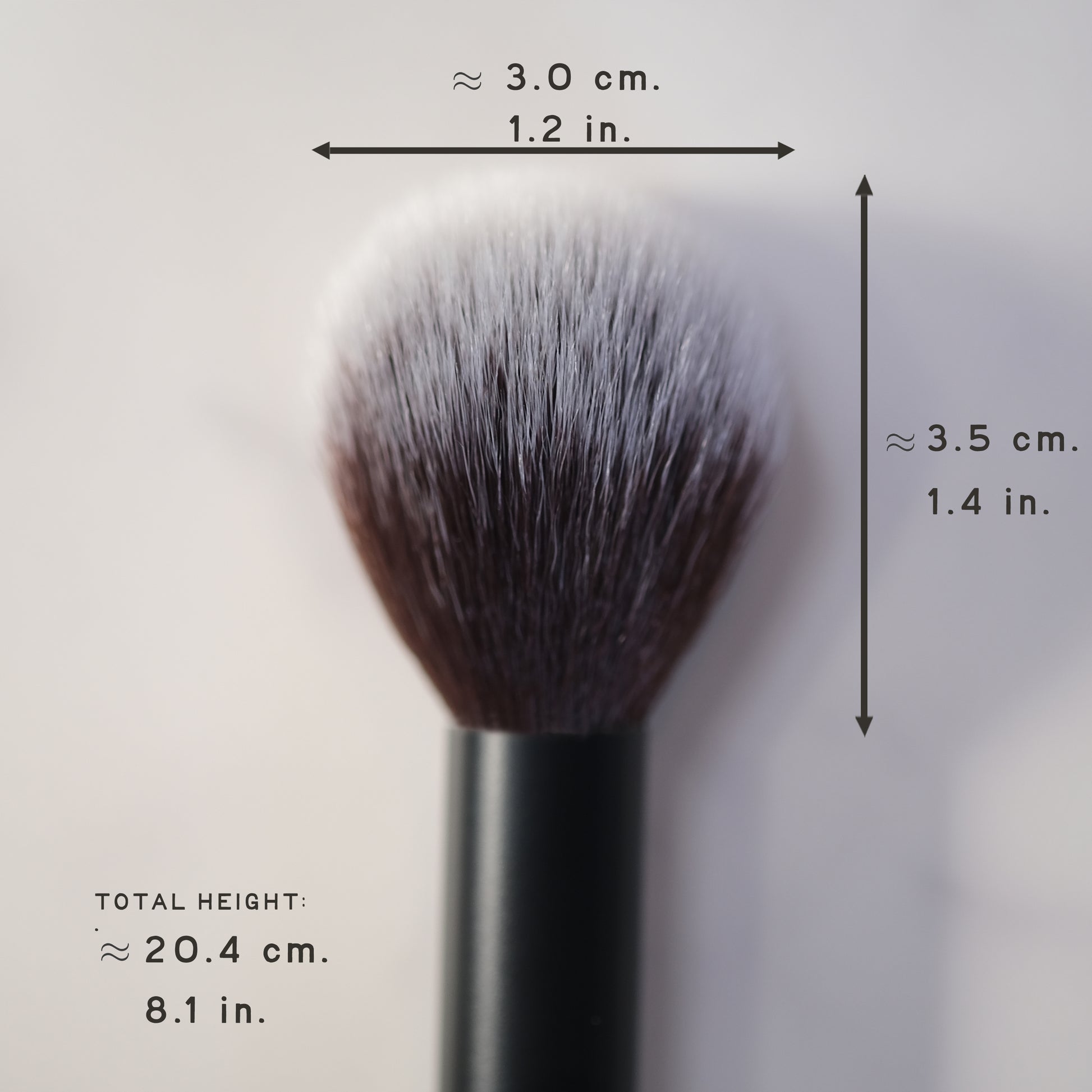 Makeup brush with measurements on a light gray background