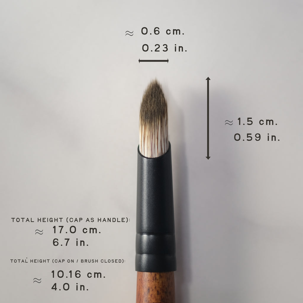 Makeup brush with measurements on a gray background