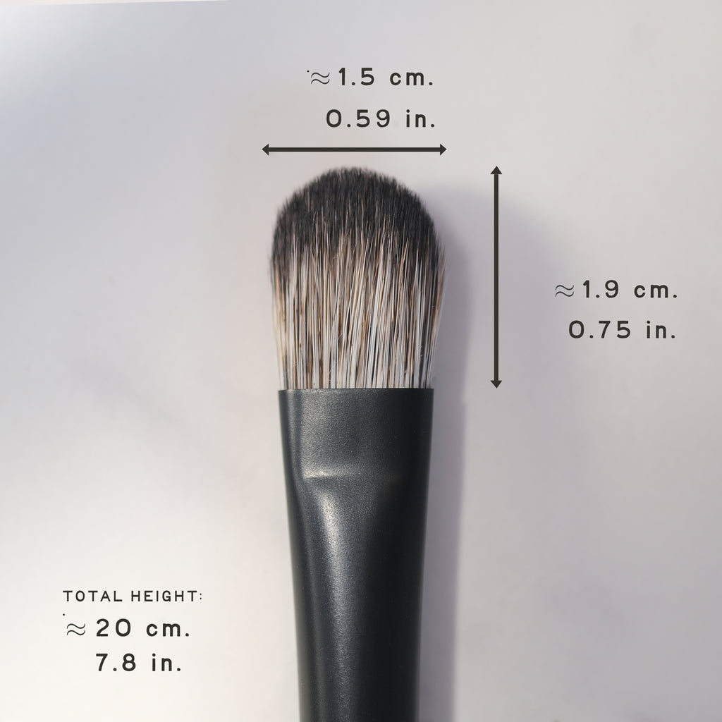 Makeup brush with measurements on a light gray background