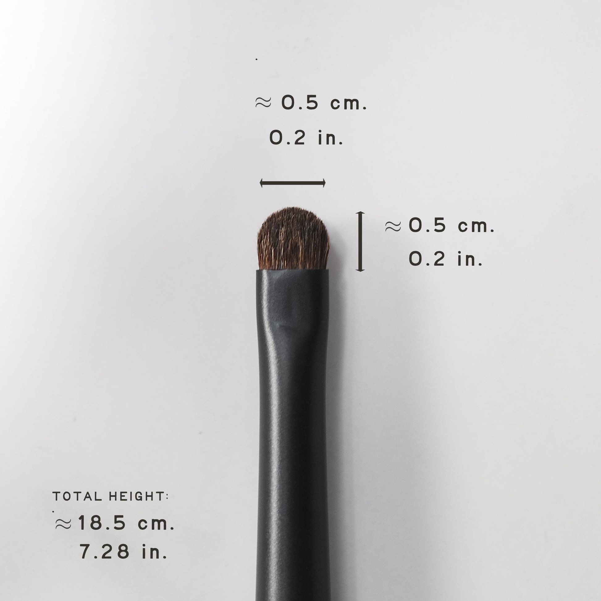 Makeup brush with measurements on a white background