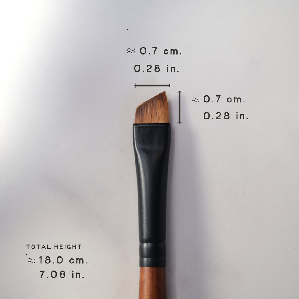 Makeup brush with measurements on a light gray background