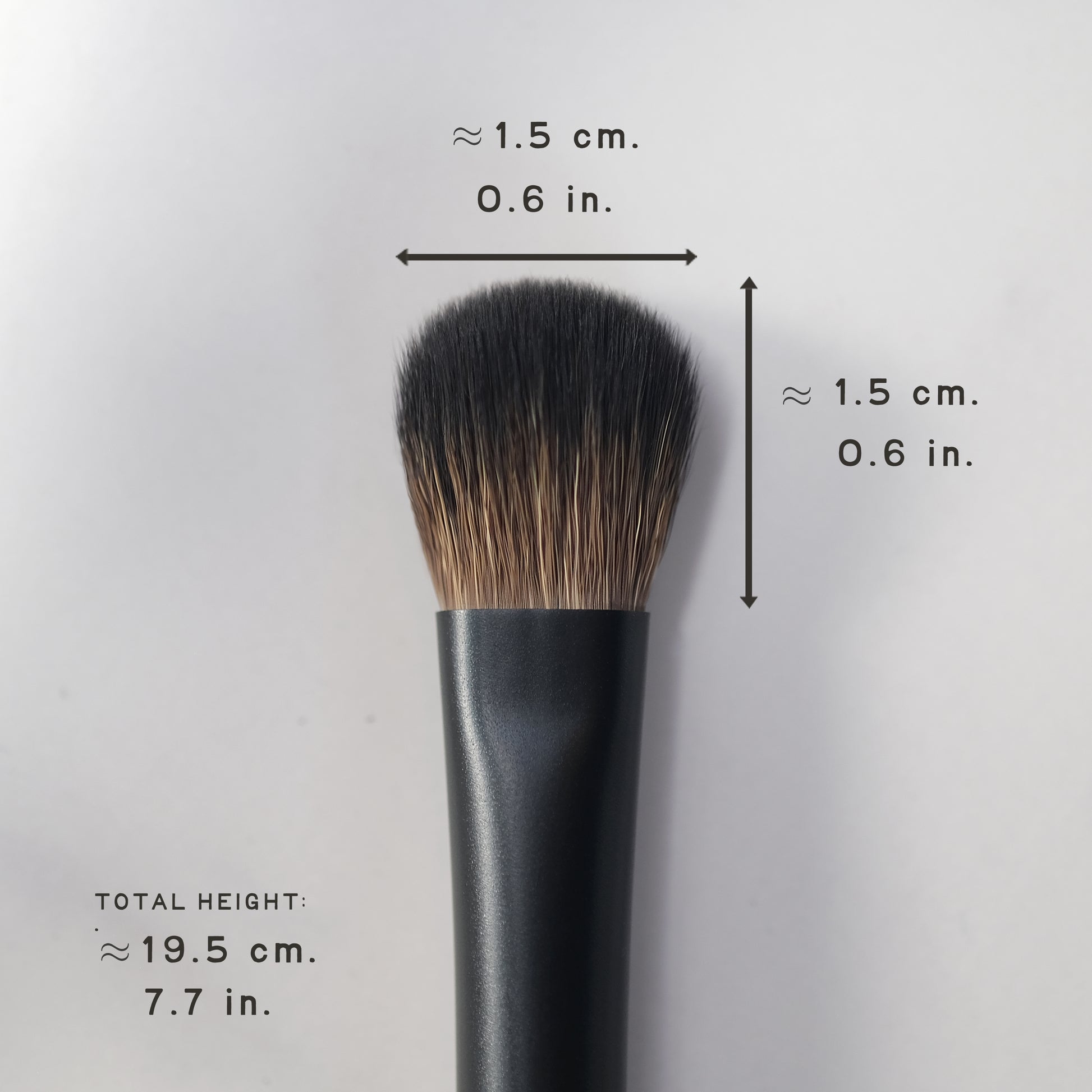 Makeup brush with measurements on a gray background