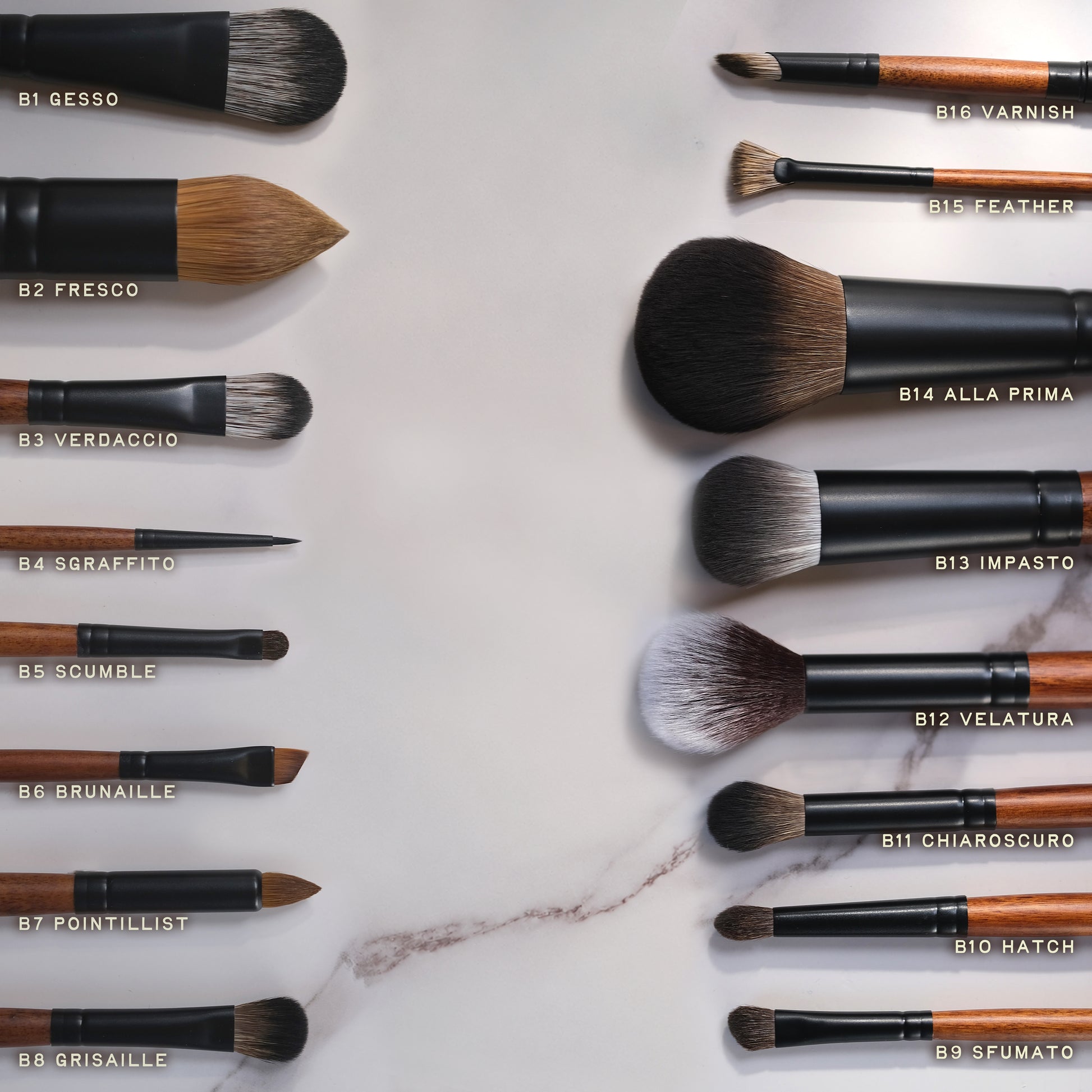 Set of makeup brushes with labels on a marble surface